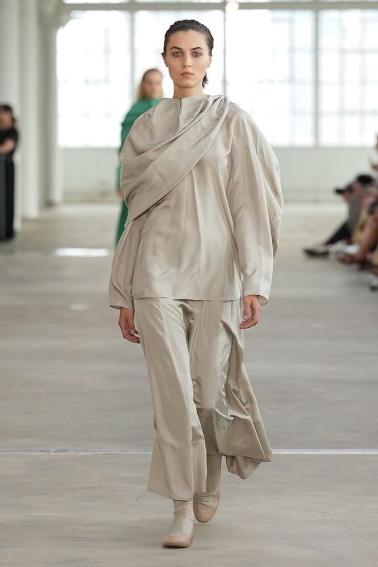 Androgynous fashion model on runway showcasing modern style